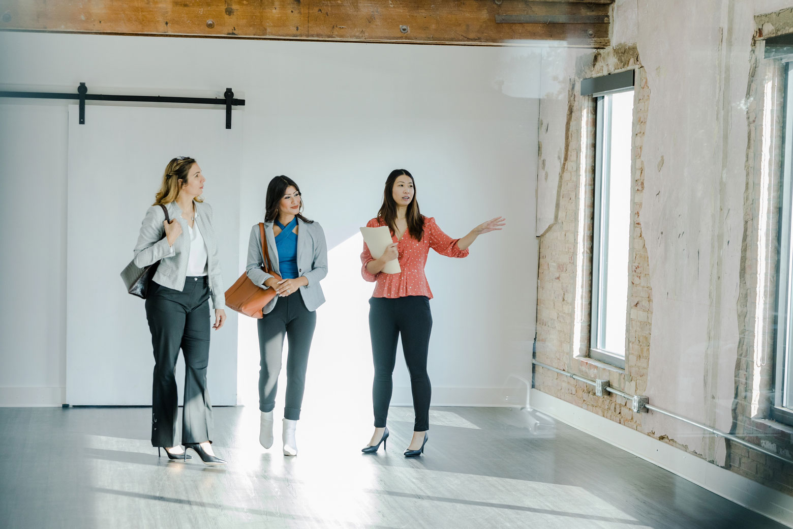 Realtor showing interested tenants an office space.