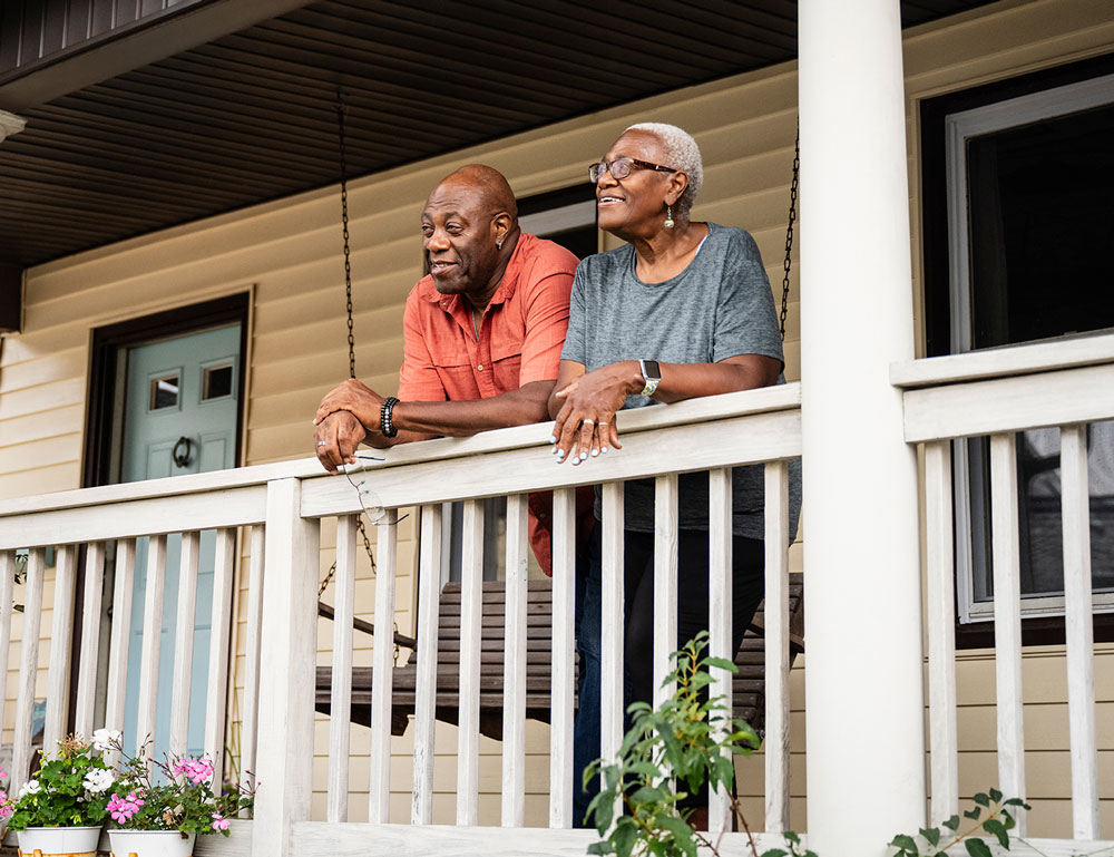 A retired couple enjoys their porch on a crisp, early fall morning