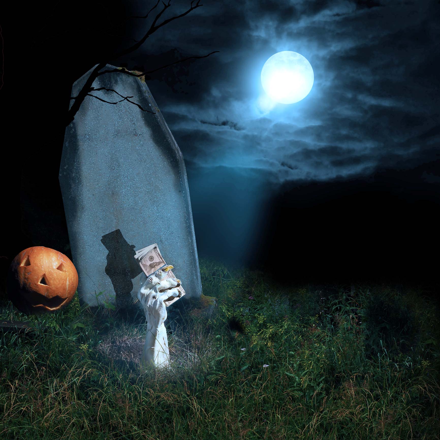 Spooky Halloween gravestone with hand coming out of the grave clutching money.